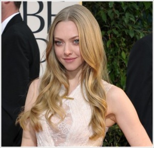 One of Hollywood's young celebrities, a woman with long wavy hair, posing at the Golden Globes.