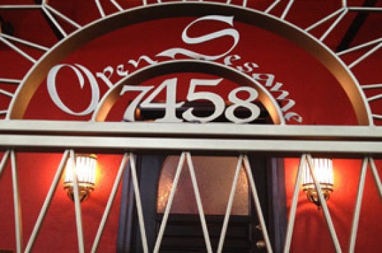 A red door with a sign that reads open seas restaurant.