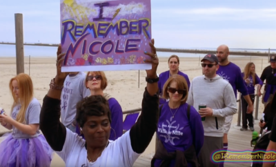 A group of people holding up a sign that says i remember mccole.