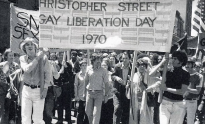 A group of people holding signs that say first street say liberation day 1970.